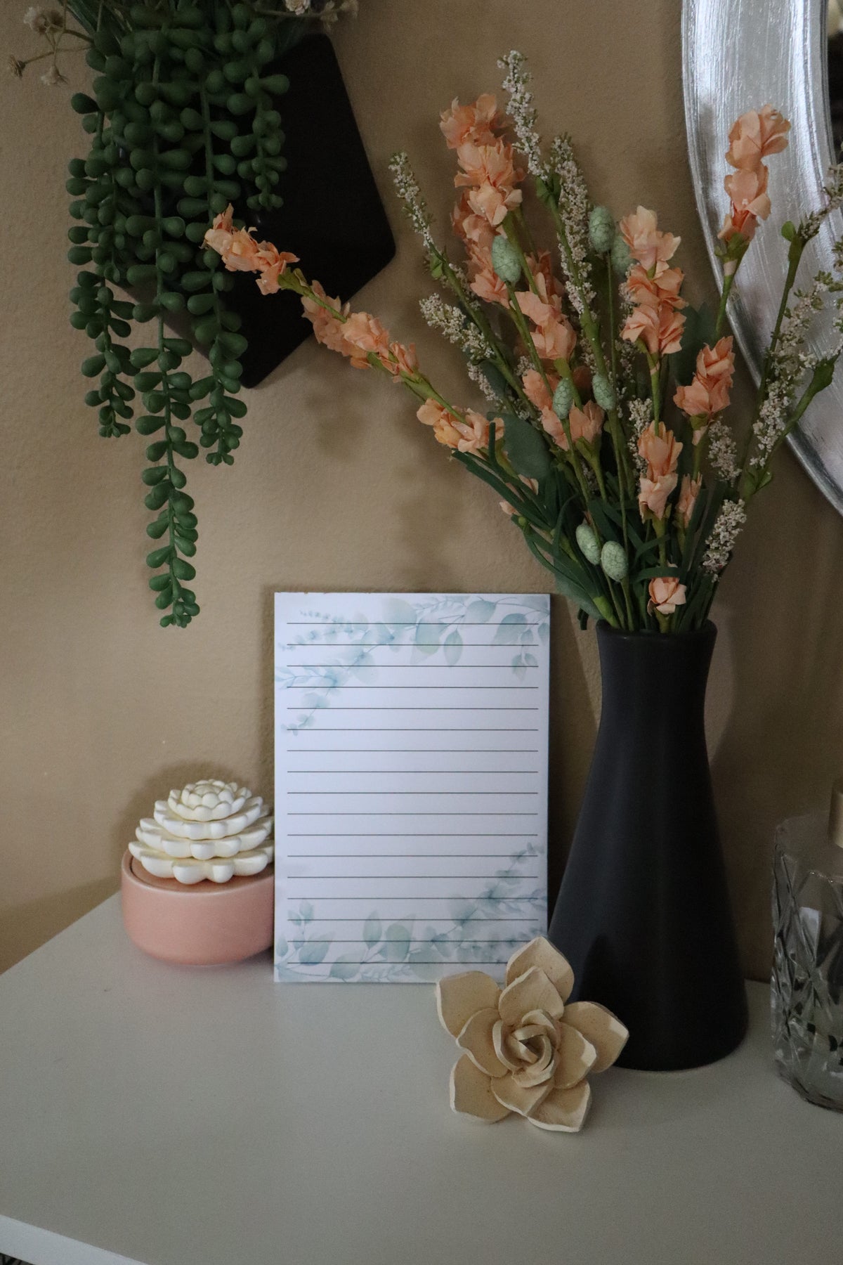 Eucalyptus watercolor lined notepad displayed with florals and succulents
