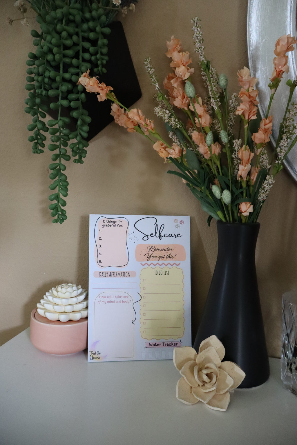 Selfcare daily planner notepad showing gratitude, affirmation, to-do list and water tracker sections