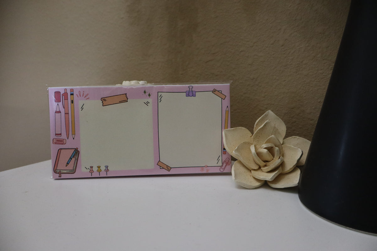 Pink stationery doodle dual notepad displayed on a white surface with a decorative flower
