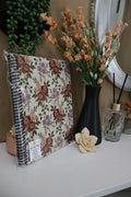 Vintage floral softcover spiral notebook displayed with peach flowers and succulents